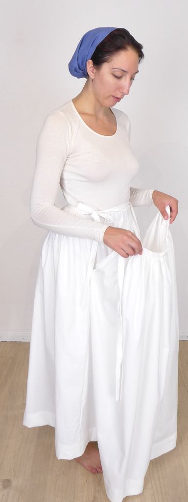 Woman holding the front part of her split waist underskirt